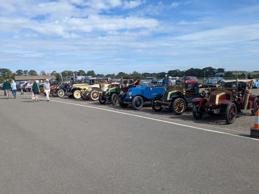 Pre-war and vintage Renault cars lined up on the airfield tarmac at the Shuttleworth Collection